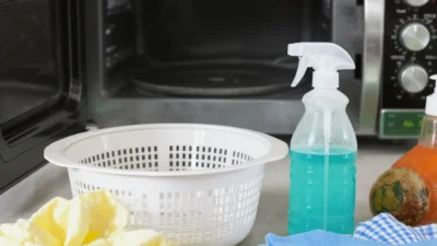 Cleaning an air fryer basket, microwave interior, and oven racks with baking soda and vinegar.
