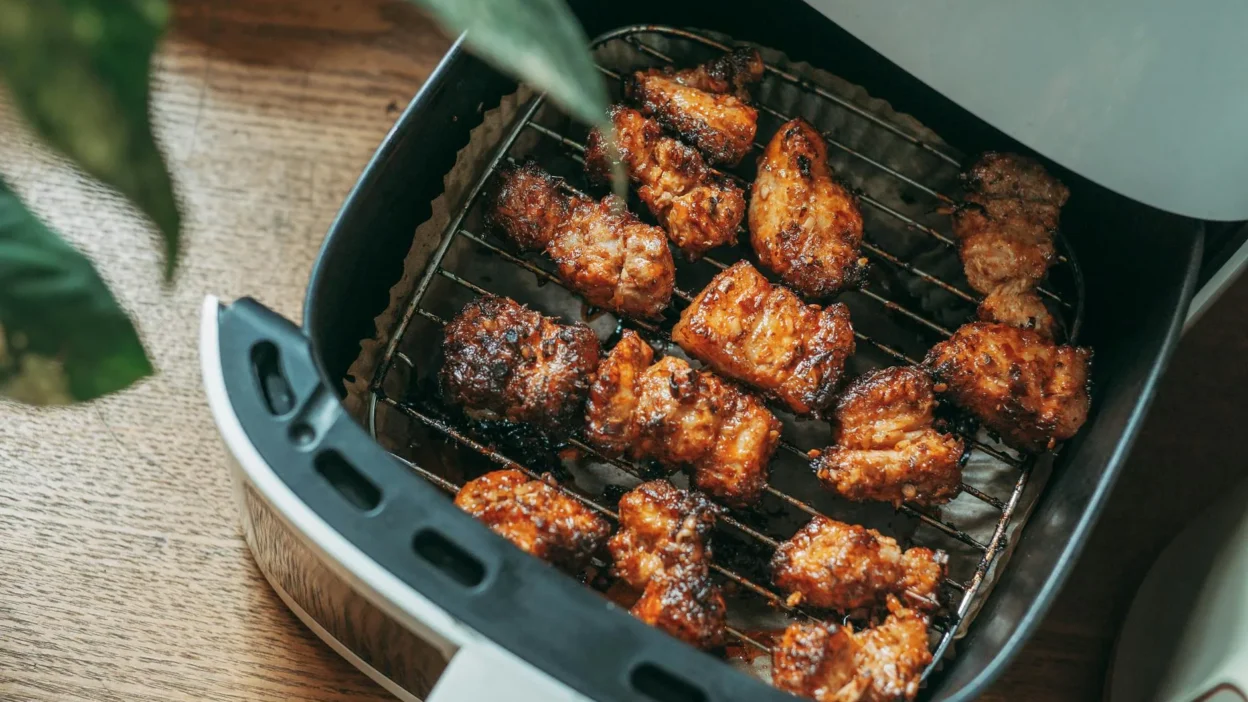 Modern air fryer on a kitchen counter with energy efficiency label and cooking timer displayed