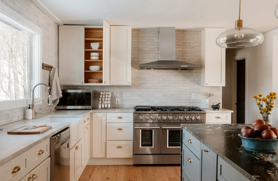 Organized kitchen cabinet with small appliances like toaster and blender stored for easy access