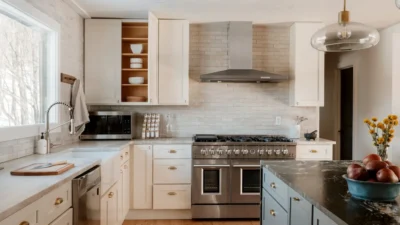 Organized kitchen cabinet with small appliances like toaster and blender stored for easy access