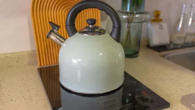 Electric kettle and stovetop kettle side-by-side comparison for energy-efficient water boiling.