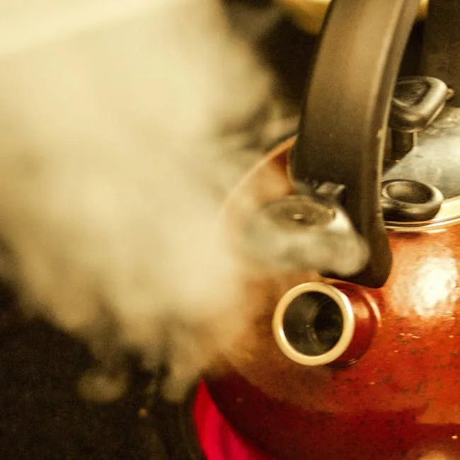 Stovetop Kettle Boiling And Releasing Steam.