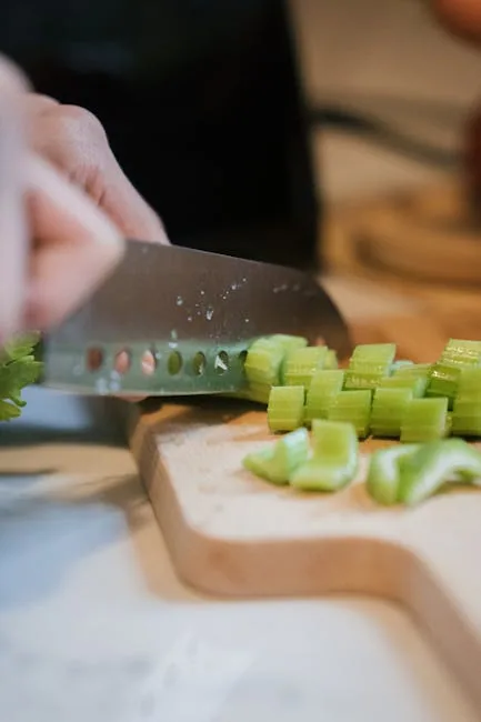 Person Chopping Vegetables On A Cutting Board