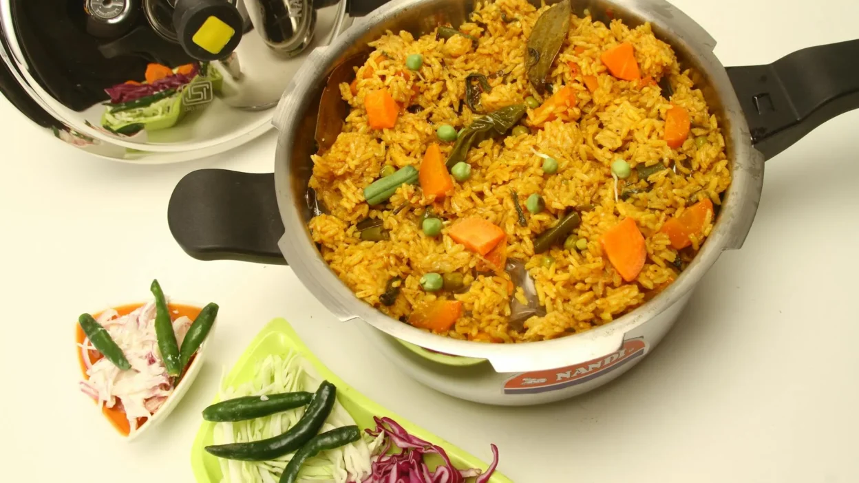 A modern rice cooker steaming vegetables and rice for an energy-saving one-pot meal.