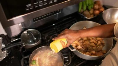 Three pots on a stovetop showing the differences between a simmer, a rolling boil, and a rapid boil for cooking.