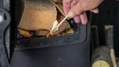 Illustration showing heat escaping from an open oven door, slowing down cooking time.